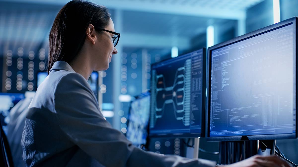 Woman using a computer with multiple displays
